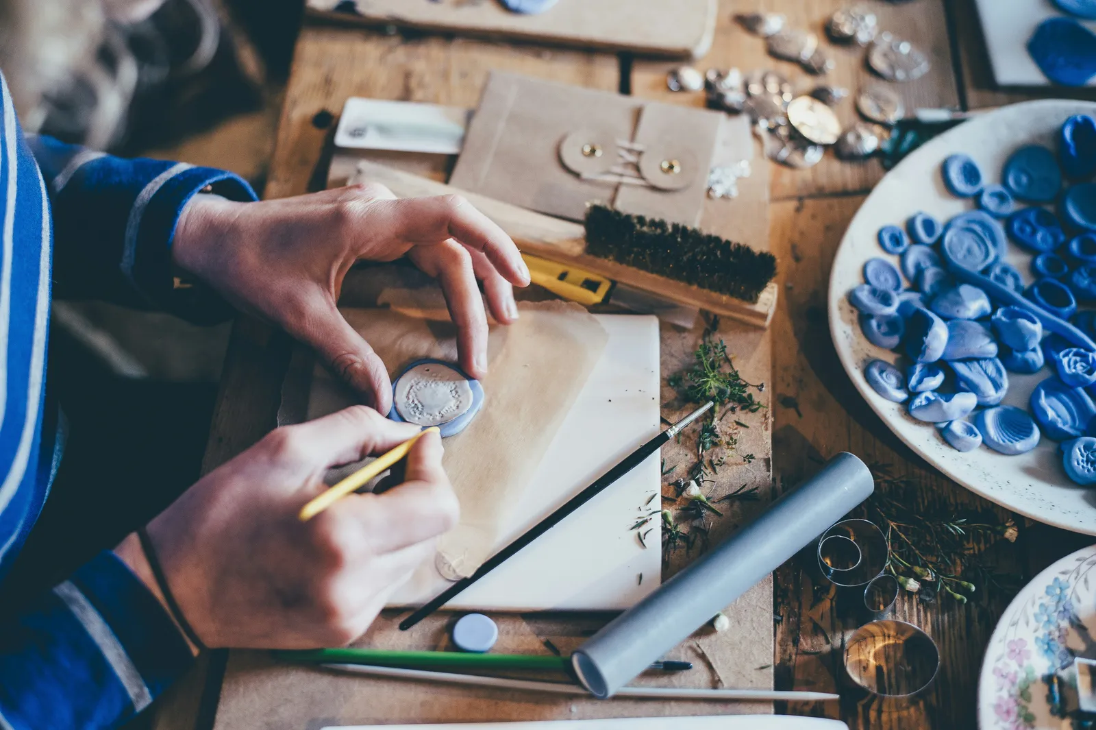 Hands crafting at a table